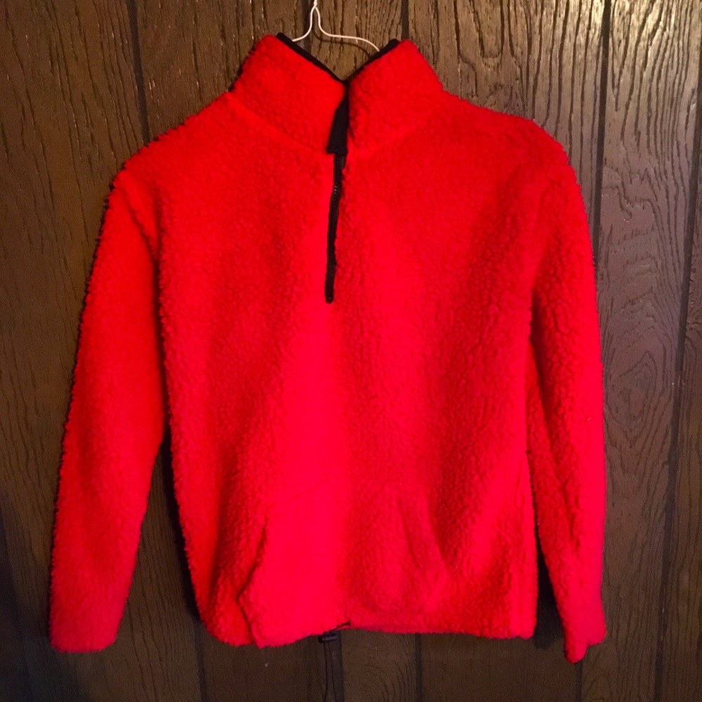 Women’s bright red turtleneck jacket.